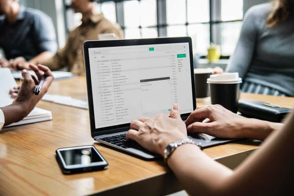Woman working on computer during meeting