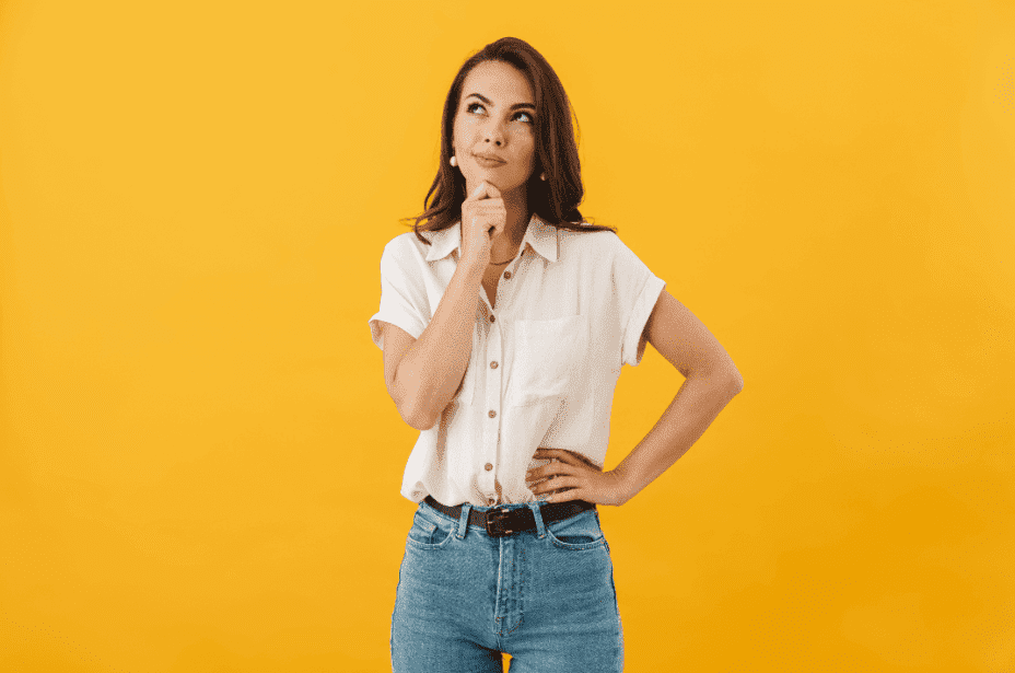 woman wondering, questioning with her hand on chin against yellow background