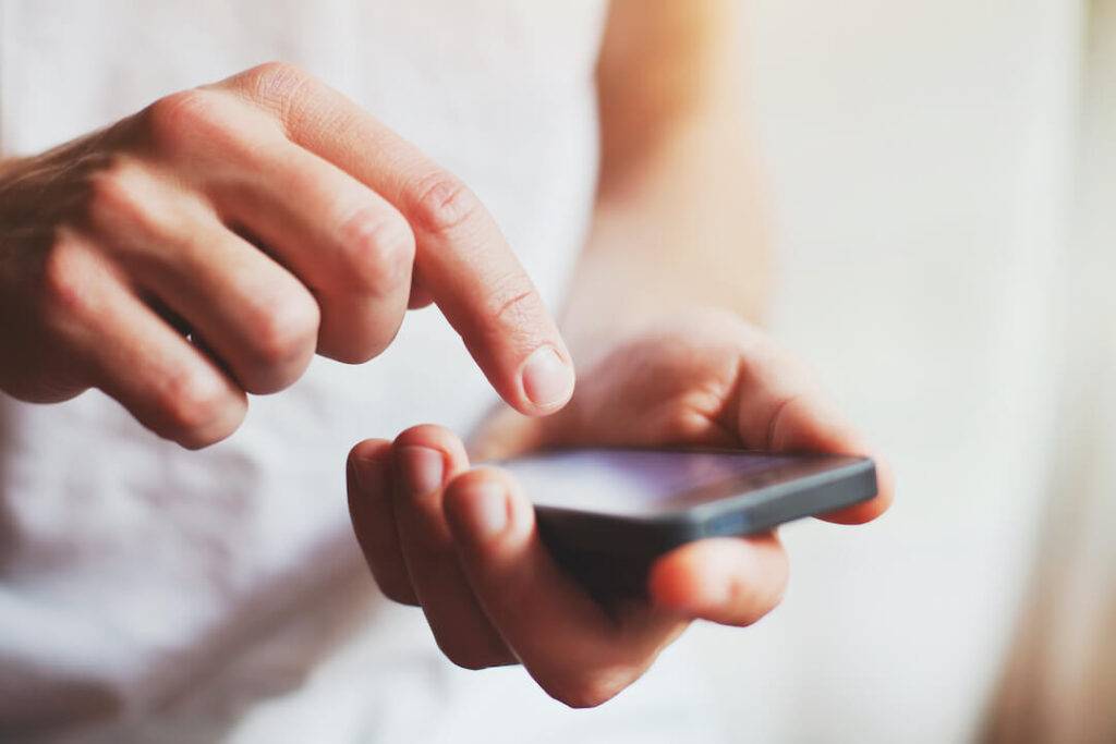 Close-Up Of Hand Holding A Cellphone